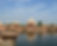 an image of the kusum sarovar in Mathura, there is blue sky and greenery in the background