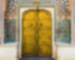 An image of a yellow door in Royal palace in Jaipur, used on the webpage of POOLit the carpool app