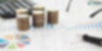 Stacks of coins on financial charts with graphs and pie chart. Calculator and pen nearby. "POOLit" logo in corner. Business theme.