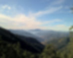 This is an image of Shimla, there are hills covered with greenery and blue sky, image used on POOLit the carpool app