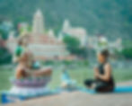 This is an image of a woman who is performing yoga in front of a river in Rishikesh, image used for POOLit the carpool app