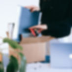 A woman is using used cardboard box for store books