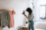 A girl taking photos of her cloths to declutter for Diwali