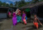 Women wearing saree standing with kids and family in a flooded village