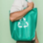 A man is using a disposable cloth bag to carry shopping items.