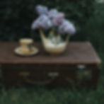 A old trunk is used as a decor piece and a old jug as a flower vase for eco-friendly lifestyle