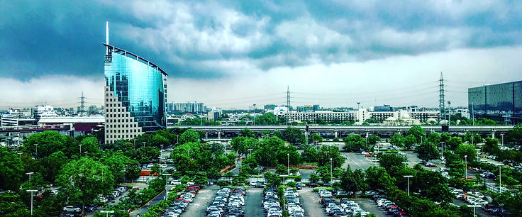 Gurgaon office buildings with car parking showing increase in number of cars in the city with time